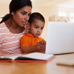 mom with a son in the computer