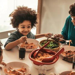 family together at the table eating