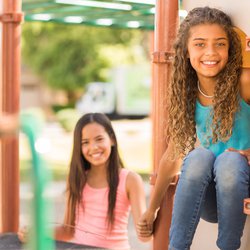 Two girls together playing in the park